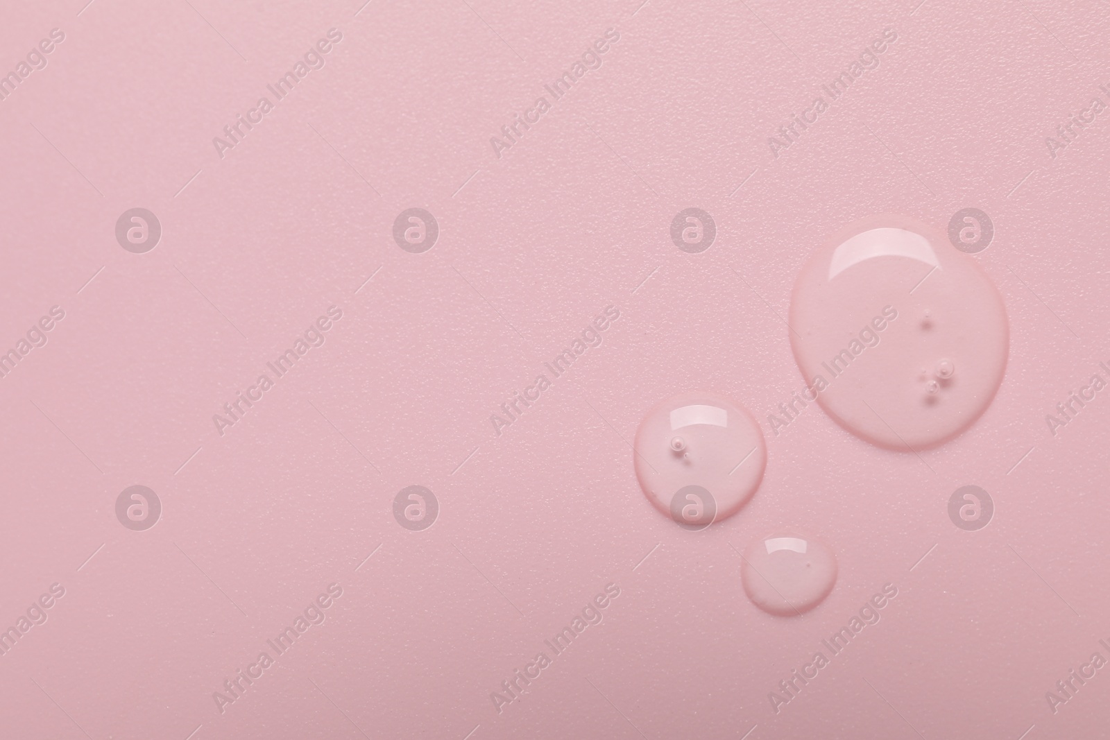 Collagen gel on pink background, top view. Space for text Photo of Collagen gel on pink background, top view. Space for text