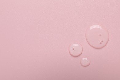 Photo of Collagen gel on pink background, top view. Space for text