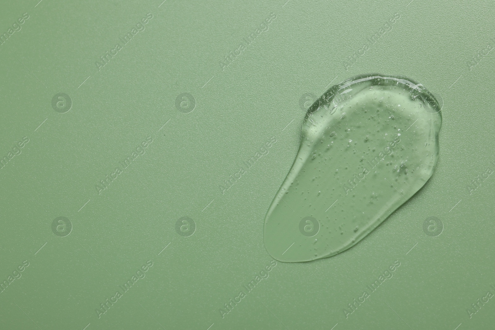 Collagen gel on green background, top view. Space for text Photo of Collagen gel on green background, top view. Space for text