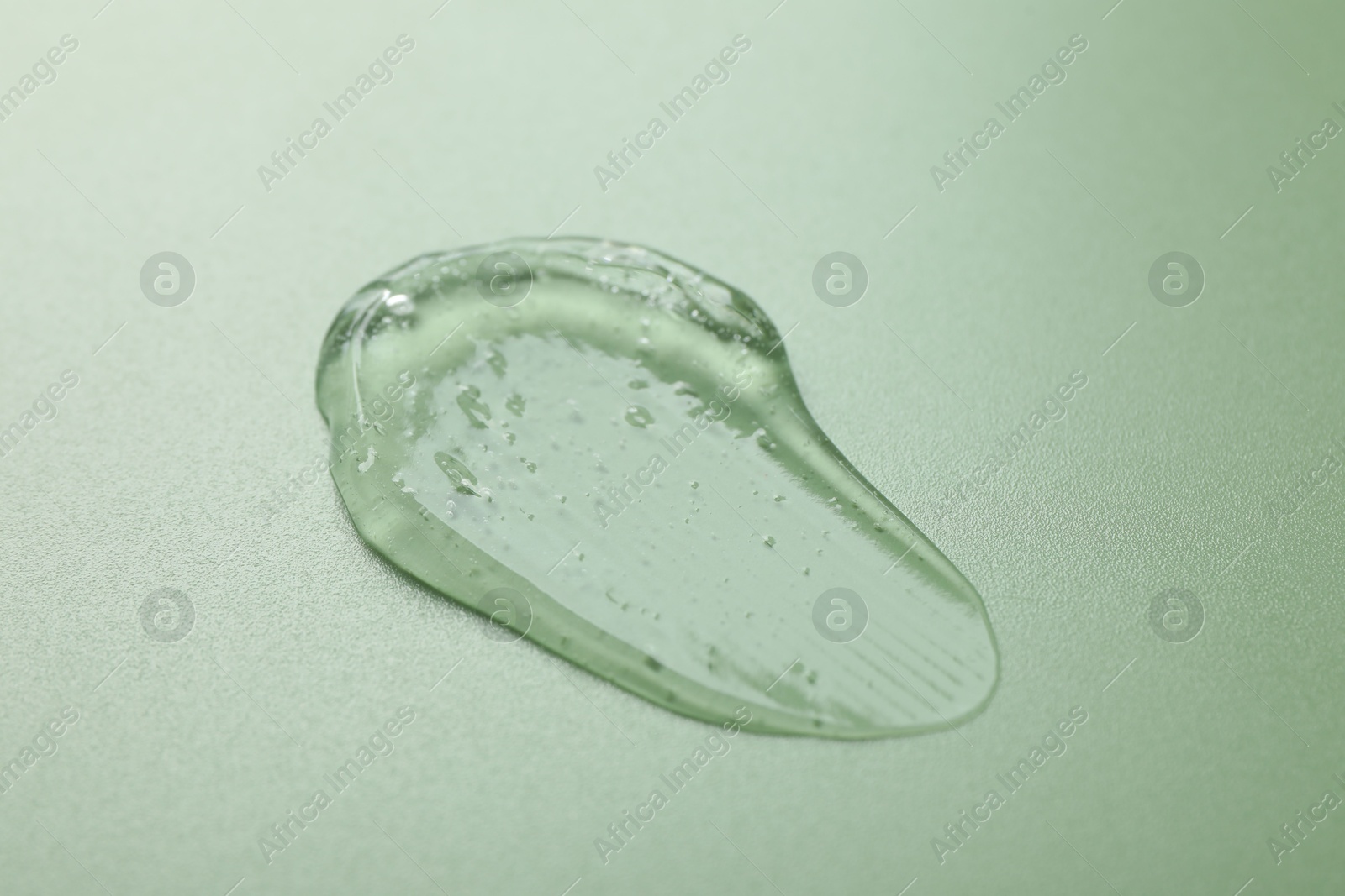 Collagen gel on green background, closeup view Photo of Collagen gel on green background, closeup view