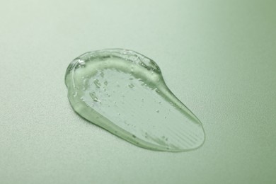 Photo of Collagen gel on green background, closeup view