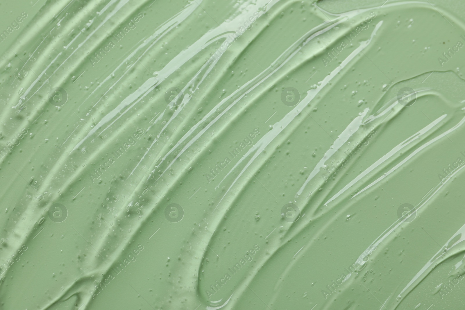 Collagen gel on green background, above view Photo of Collagen gel on green background, above view