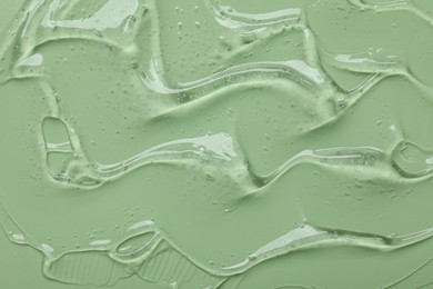 Photo of Collagen gel on green background, top view