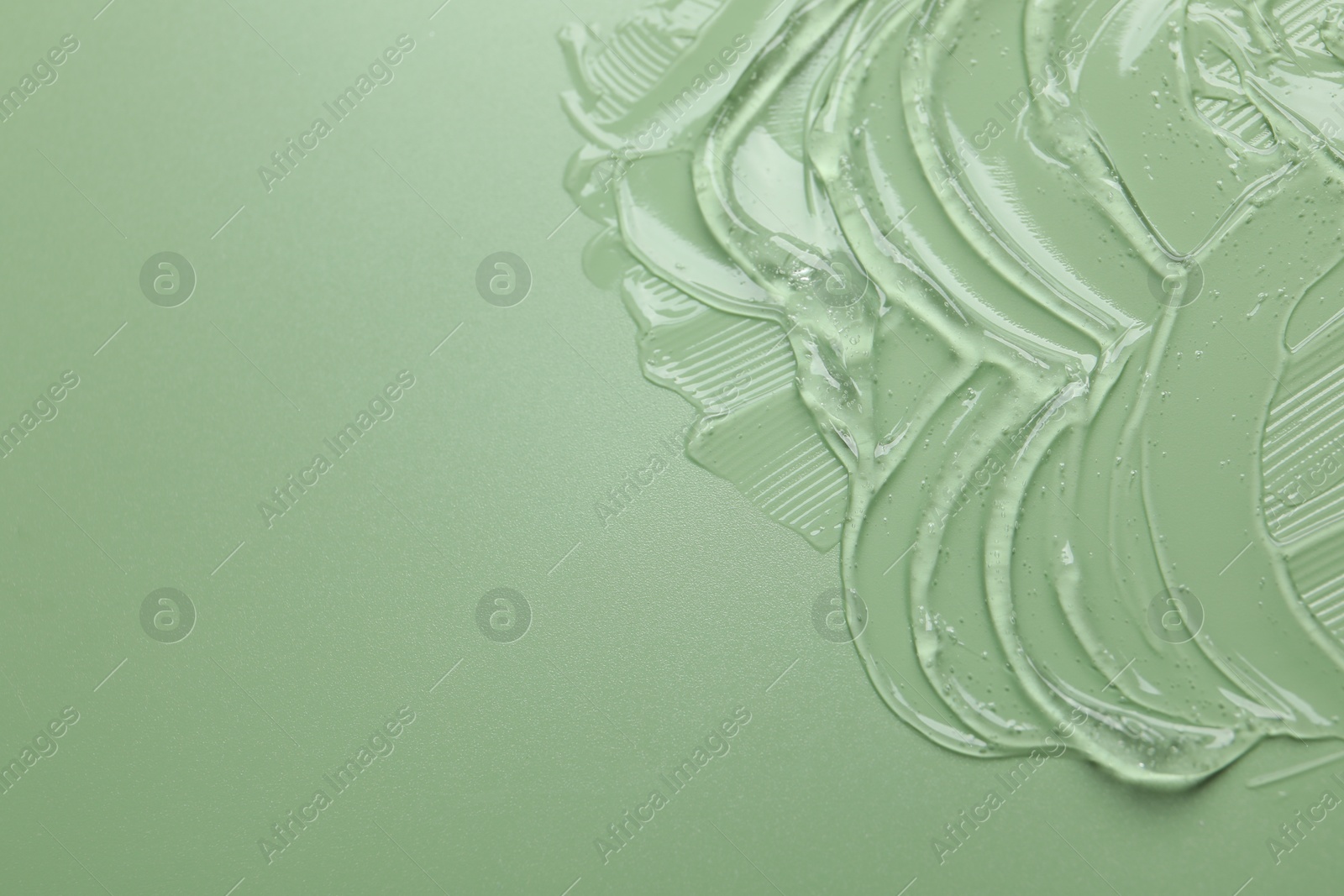 Photo of Collagen gel on green background, above view. Space for text