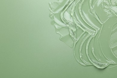 Photo of Collagen gel on green background, above view. Space for text