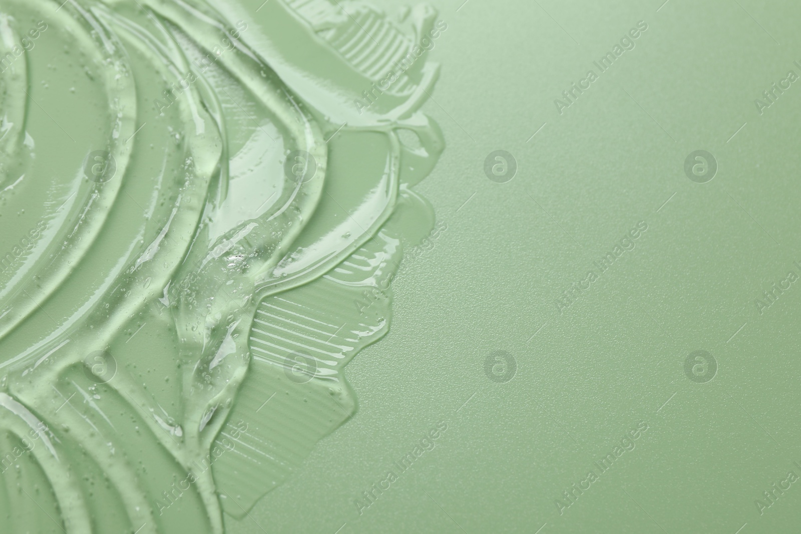 Collagen gel on green background, above view. Space for text Photo of Collagen gel on green background, above view. Space for text