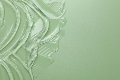 Photo of Collagen gel on green background, above view. Space for text