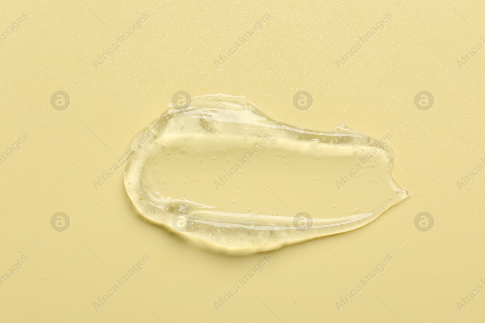 Photo of Collagen gel on yellow background, above view. Space for text