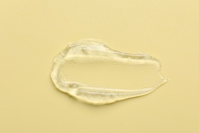 Photo of Collagen gel on yellow background, above view. Space for text