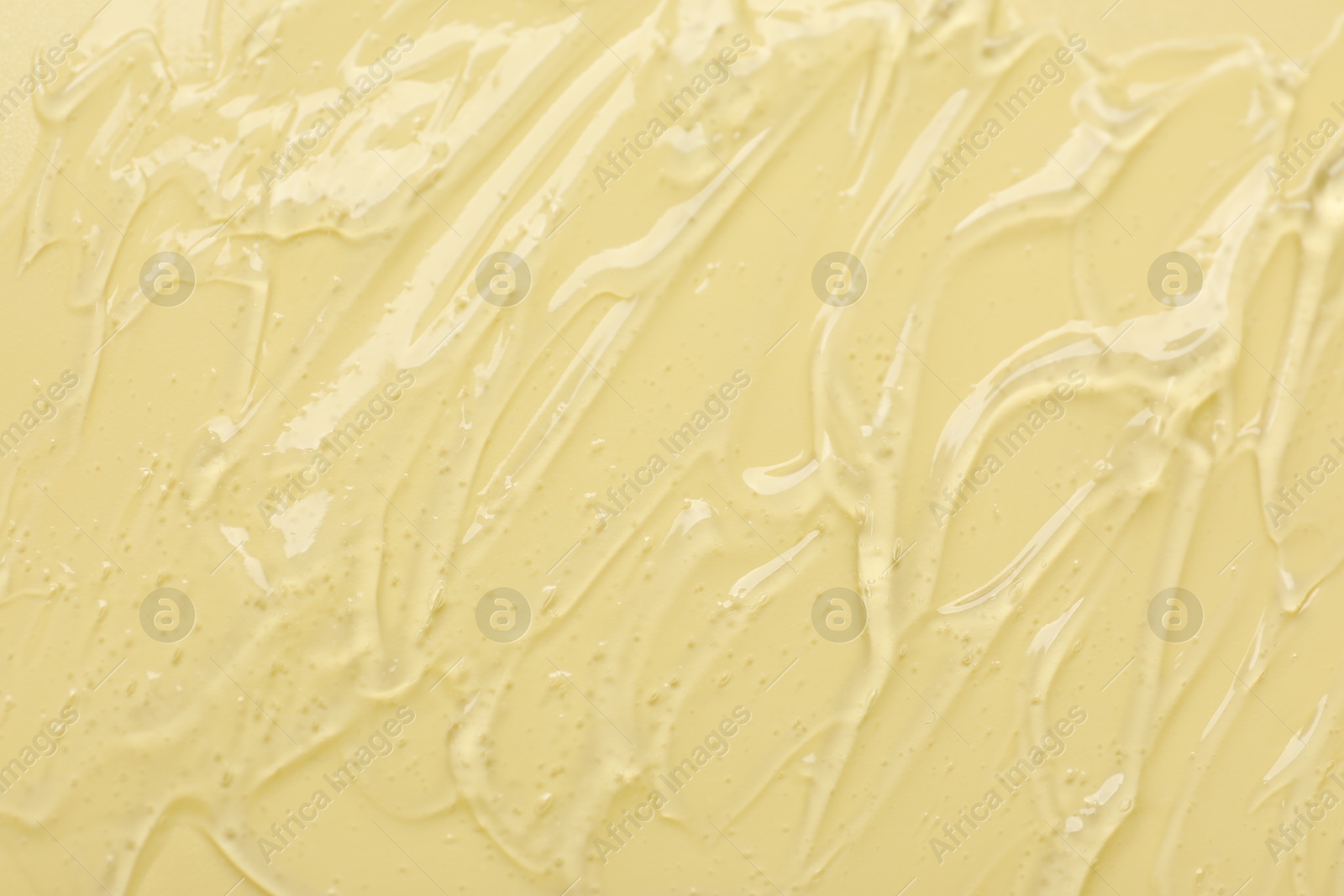 Collagen gel on yellow background, top view Photo of Collagen gel on yellow background, top view