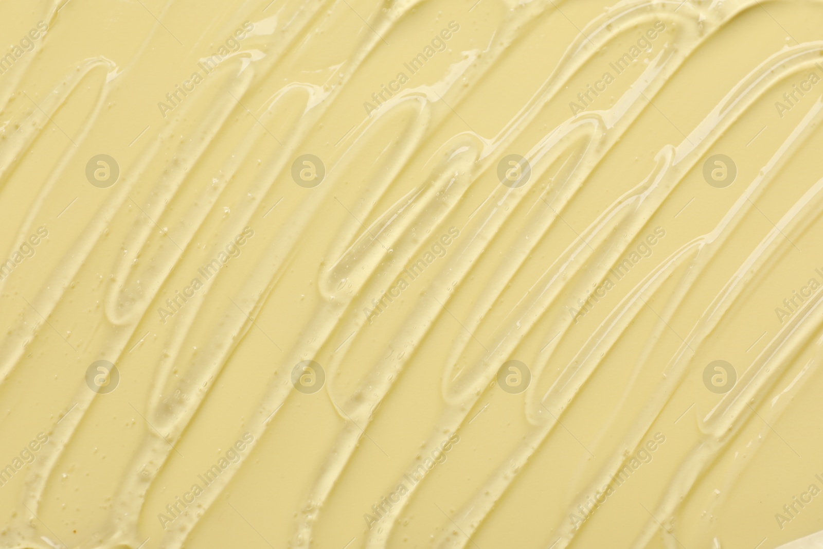 Collagen gel on yellow background, top view Photo of Collagen gel on yellow background, top view