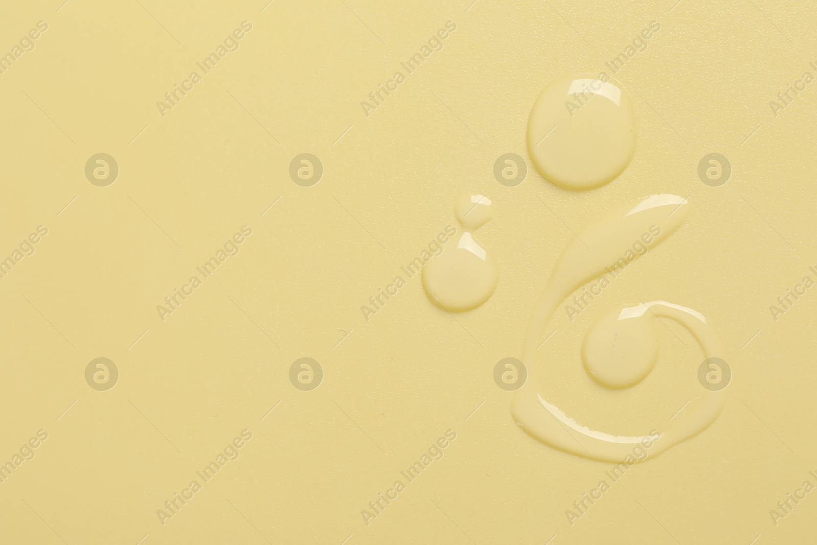 Collagen gel on yellow background, top view. Space for text Photo of Collagen gel on yellow background, top view. Space for text