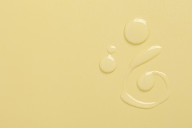 Photo of Collagen gel on yellow background, top view. Space for text
