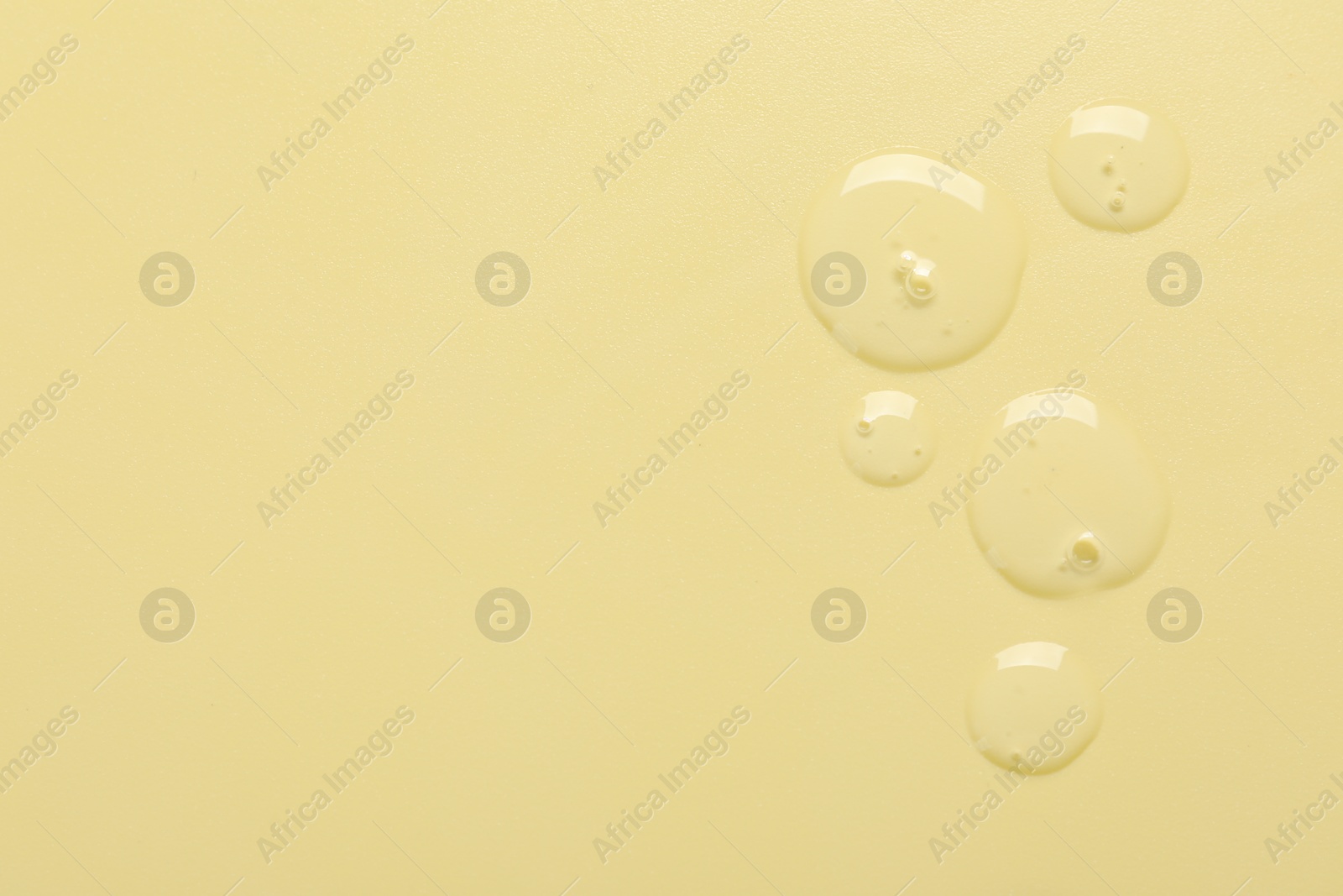 Collagen gel on yellow background, top view. Space for text Photo of Collagen gel on yellow background, top view. Space for text