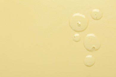 Photo of Collagen gel on yellow background, top view. Space for text
