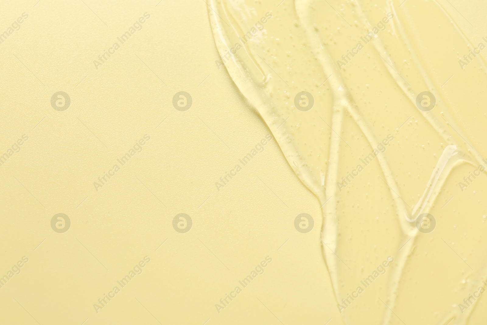 Collagen gel on yellow background, top view. Space for text Photo of Collagen gel on yellow background, top view. Space for text