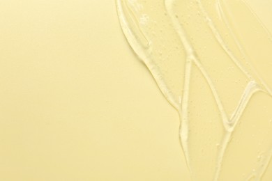 Photo of Collagen gel on yellow background, top view. Space for text