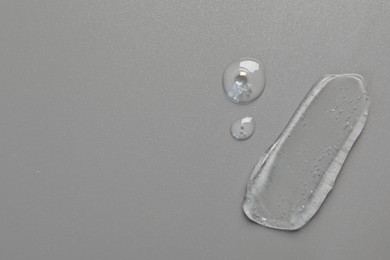 Photo of Collagen gel on grey background, top view. Space for text