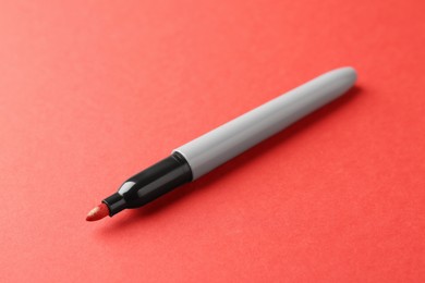 Photo of One color marker on red background, closeup. Space for text
