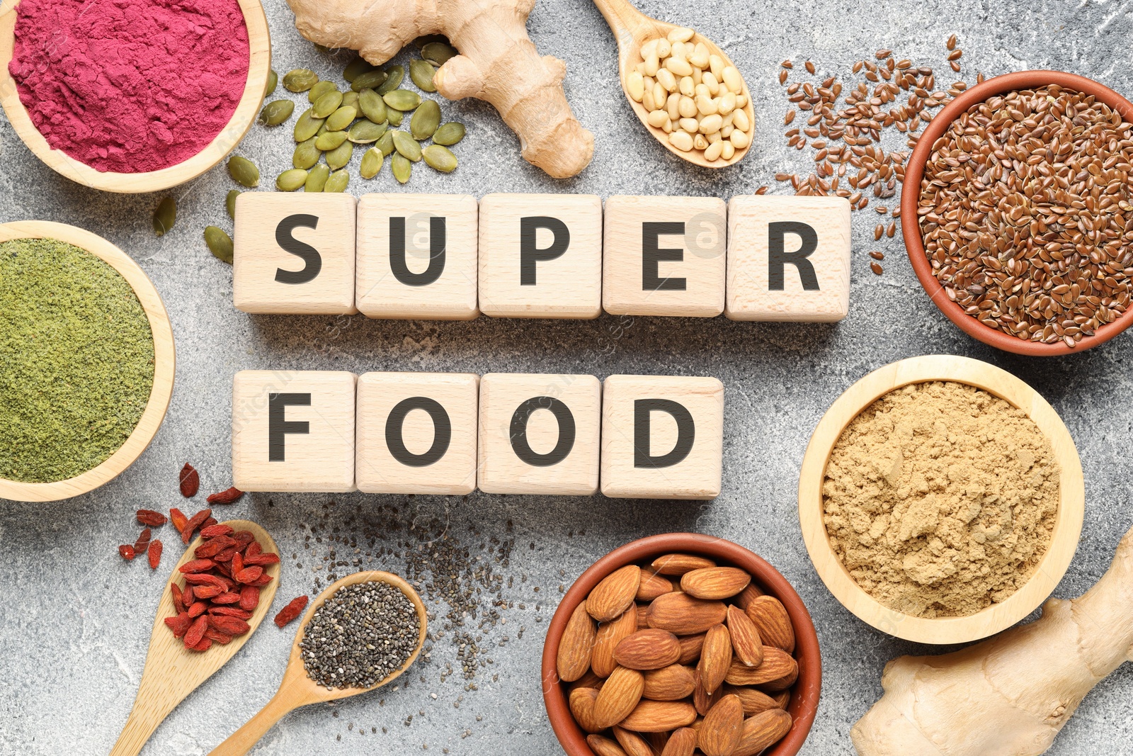 Wooden cubes with words Super Food, products and supplements on grey textured table, flat lay Photo of Wooden cubes with words Super Food, products and supplements on grey textured table, flat lay