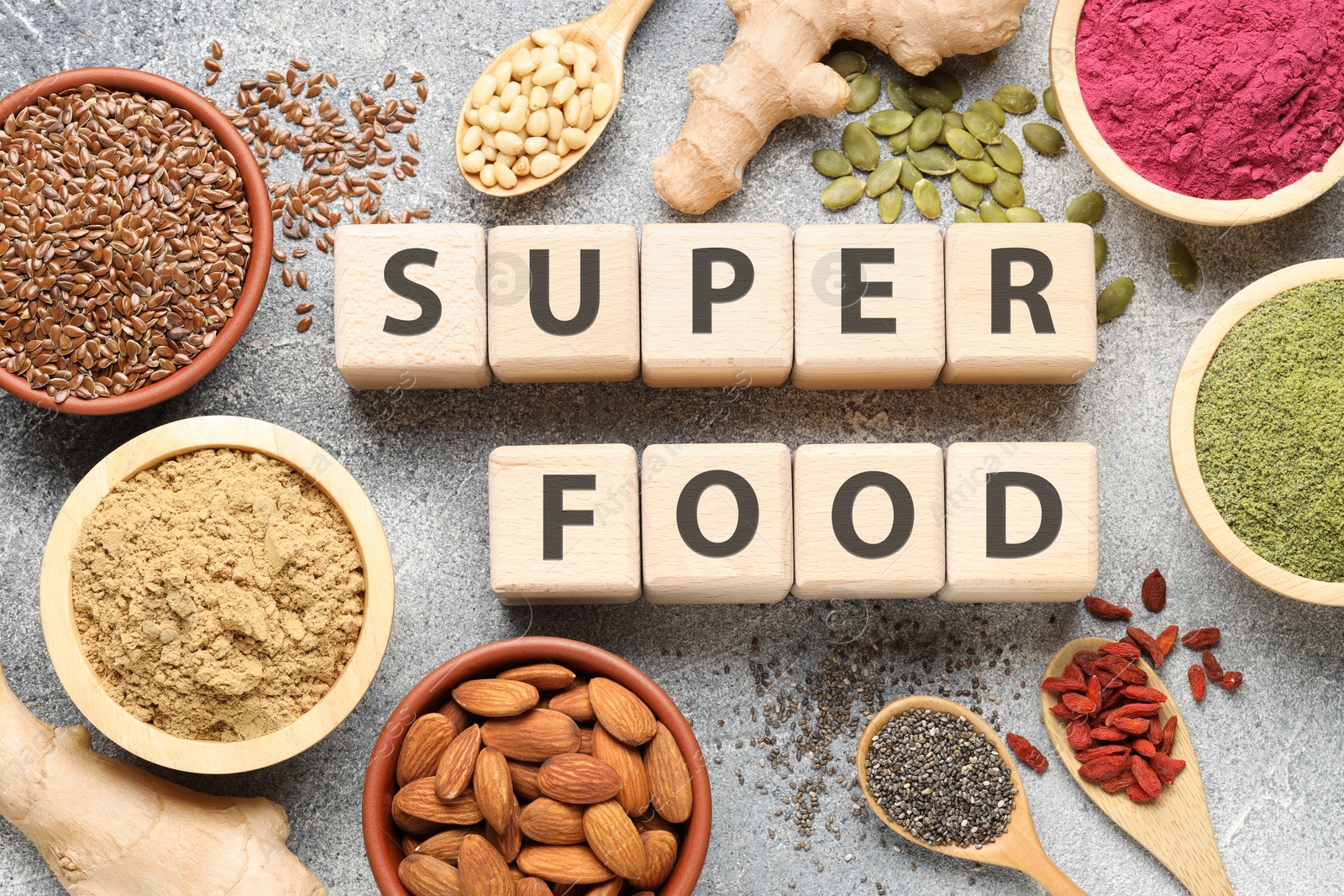 Wooden cubes with words Super Food, products and supplements on grey textured table, flat lay Photo of Wooden cubes with words Super Food, products and supplements on grey textured table, flat lay