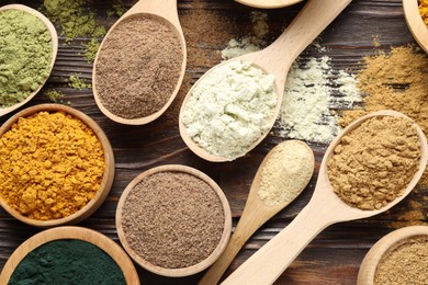 Photo of Different superfood powders on wooden table, flat lay