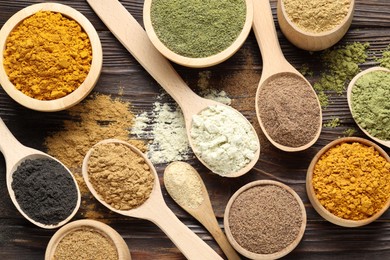 Photo of Different superfood powders on wooden table, flat lay