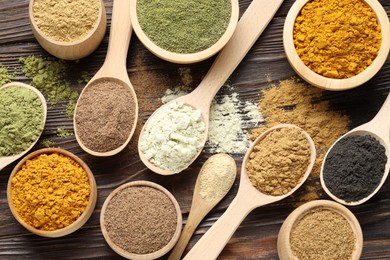 Photo of Different superfood powders on wooden table, flat lay