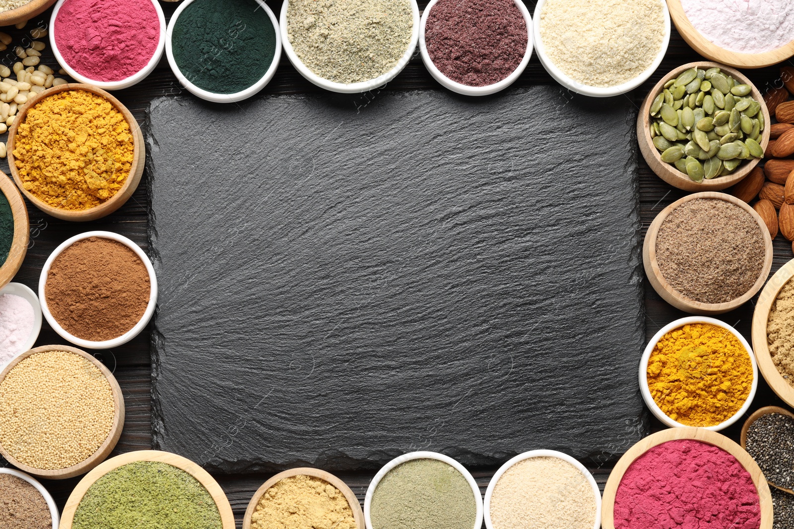Different superfood powders and slate board on wooden table, flat lay. Space for text Photo of Different superfood powders and slate board on wooden table, flat lay. Space for text