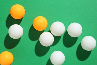 Photo of Ping pong balls on green background, flat lay
