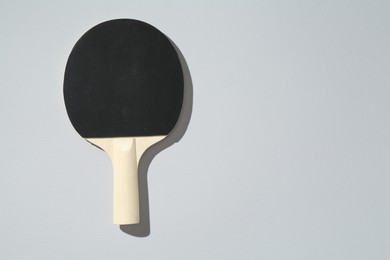 Photo of One ping pong racket on light background, top view. Space for text