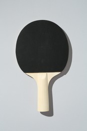 Photo of One ping pong racket on light background, top view