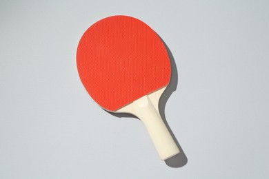 Photo of One ping pong racket on light background, top view