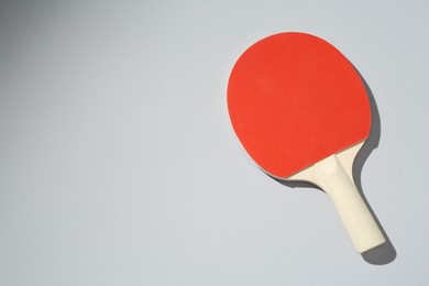 Photo of One ping pong racket on light background, top view. Space for text