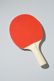 Photo of One ping pong racket on light background, top view