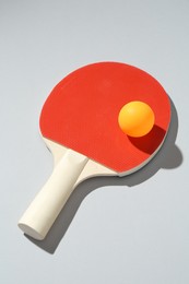 Photo of Ping pong racket and ball on light background