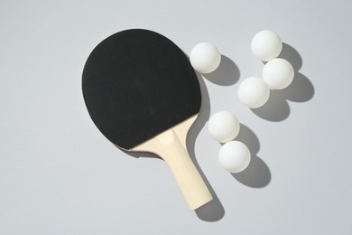 Photo of Ping pong racket and balls on light background, flat lay