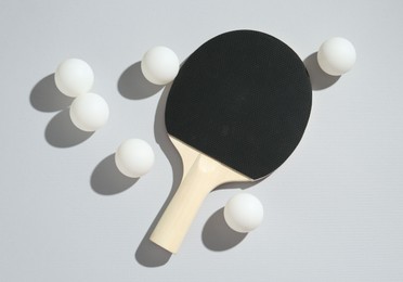 Photo of Ping pong racket and balls on light background, flat lay