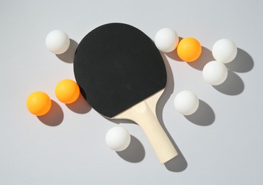 Photo of Ping pong racket and balls on light background, flat lay