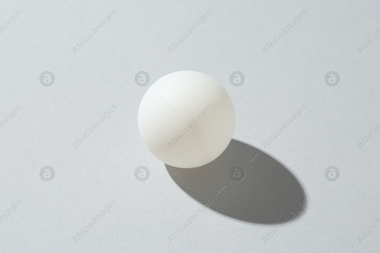 One ping pong ball on light background, closeup Photo of One ping pong ball on light background, closeup