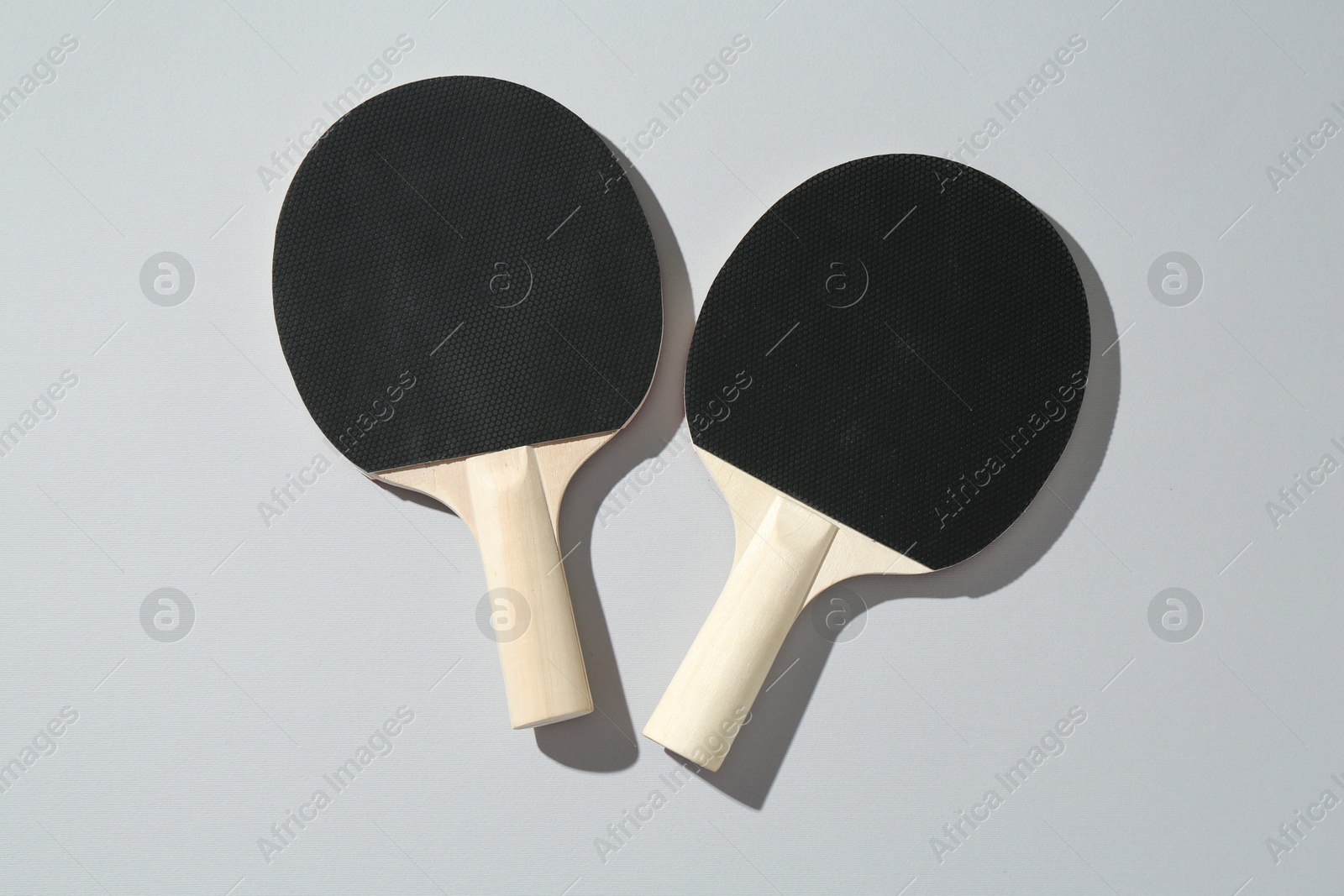 Ping pong rackets on light background, top view Photo of Ping pong rackets on light background, top view