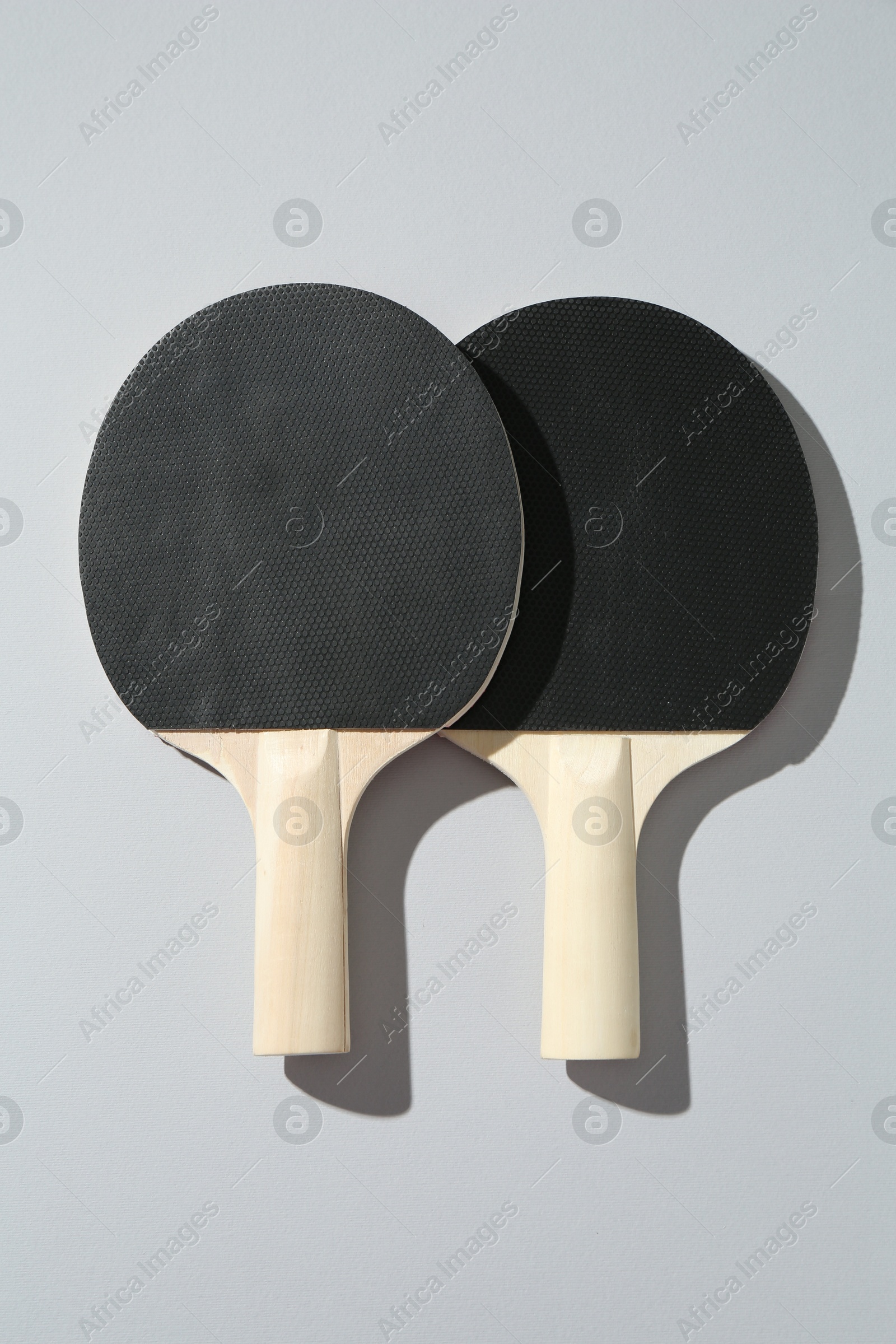 Ping pong rackets on light background, top view Photo of Ping pong rackets on light background, top view