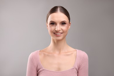 Photo of Portrait of beautiful young woman on gray background