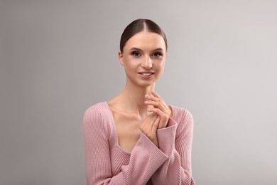 Photo of Portrait of beautiful young woman on gray background