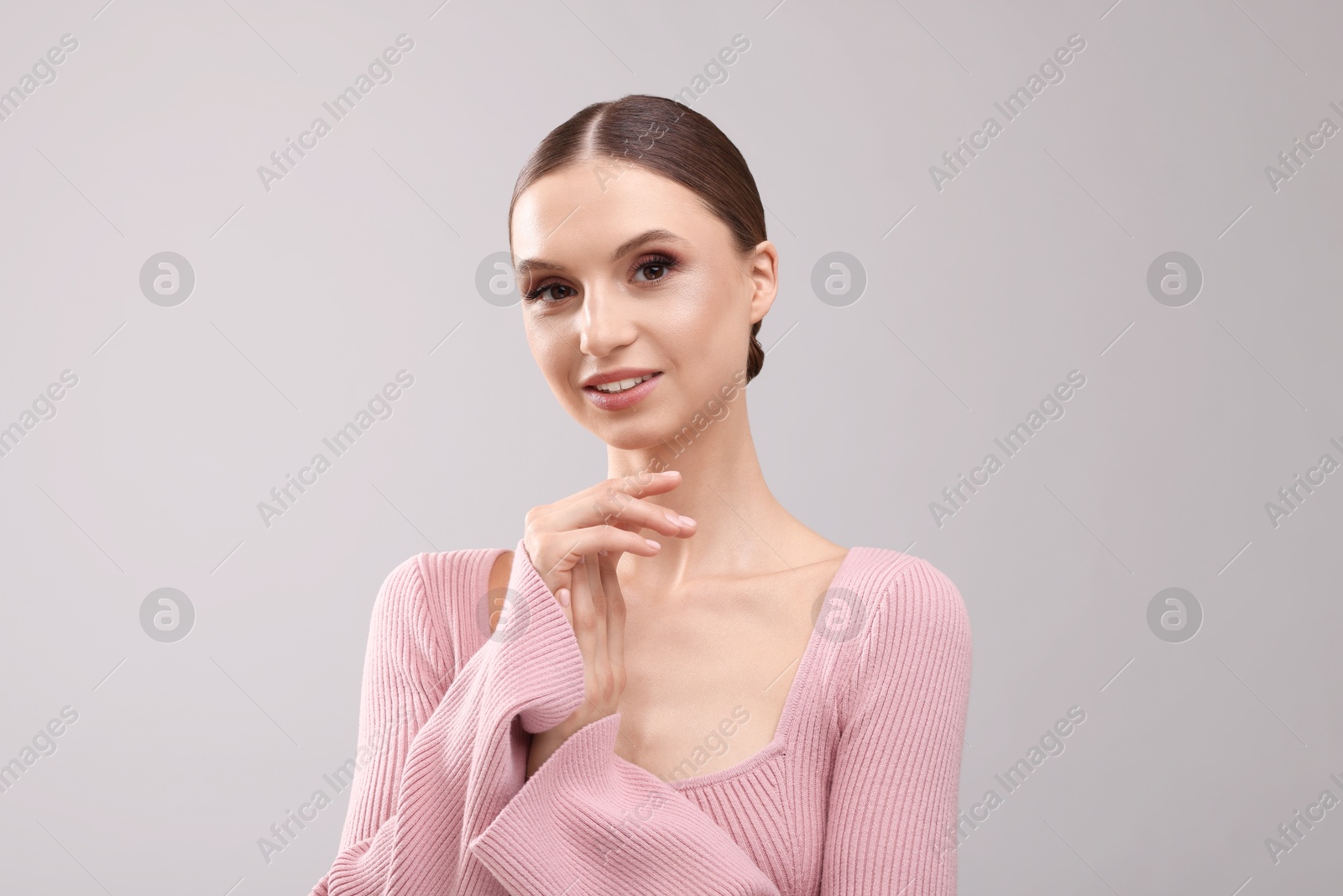Portrait of beautiful young woman on gray background Photo of Portrait of beautiful young woman on gray background