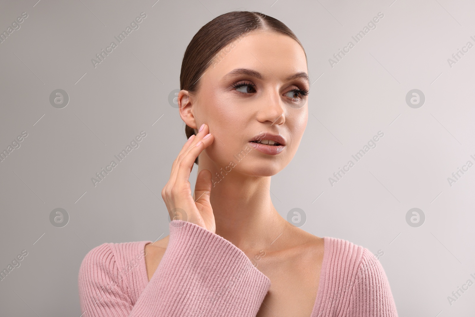Portrait of beautiful young woman on gray background Photo of Portrait of beautiful young woman on gray background