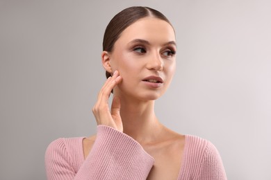 Photo of Portrait of beautiful young woman on gray background