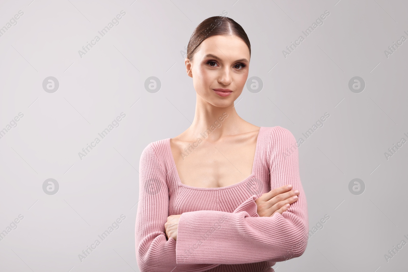 Portrait of beautiful young woman on gray background Photo of Portrait of beautiful young woman on gray background