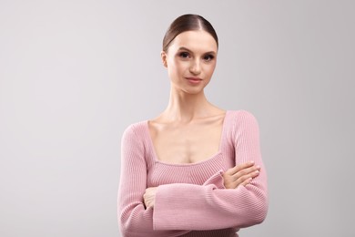 Photo of Portrait of beautiful young woman on gray background