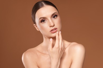 Photo of Portrait of beautiful young woman on beige background